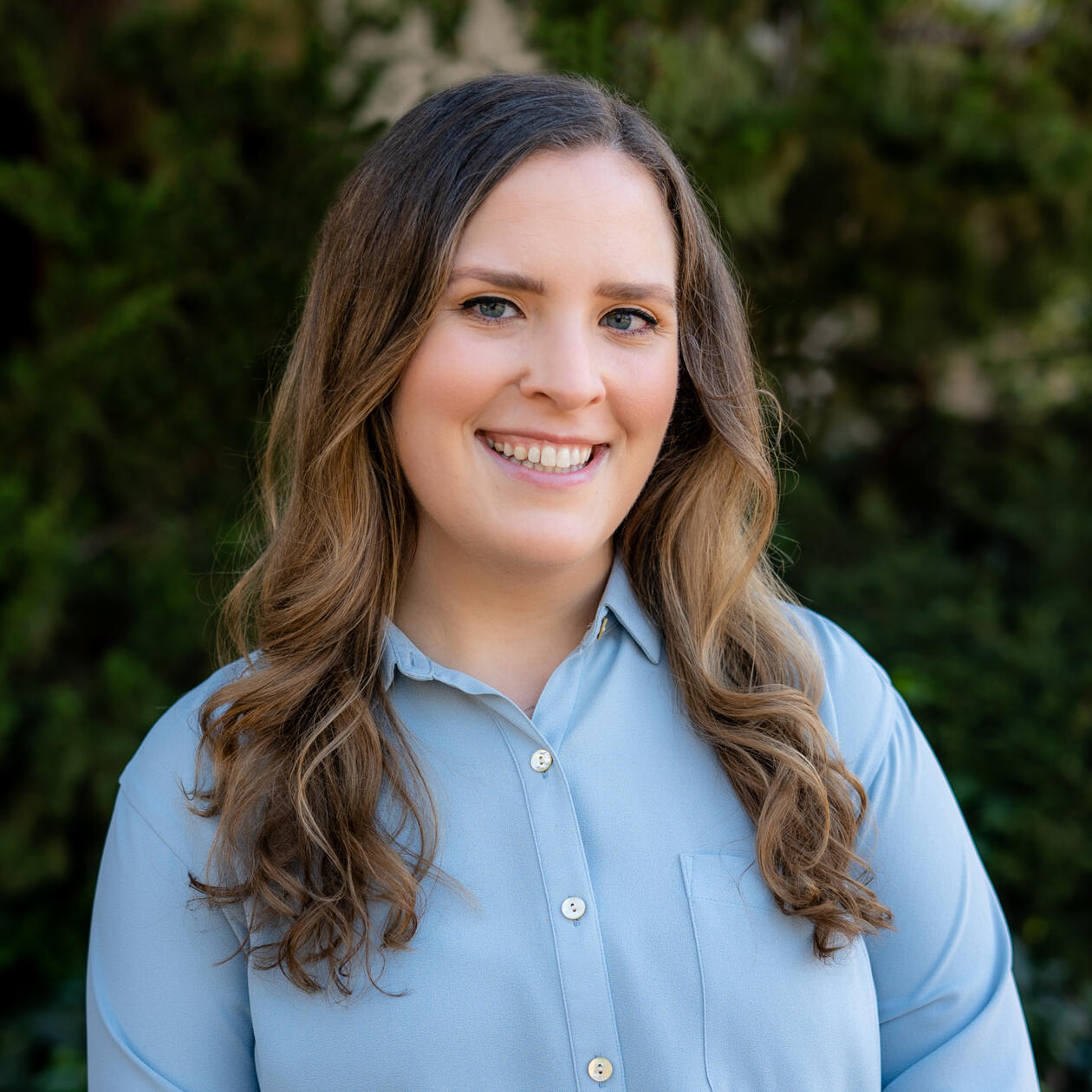 Image of Ashley Haylett wearing a blue collared blouse